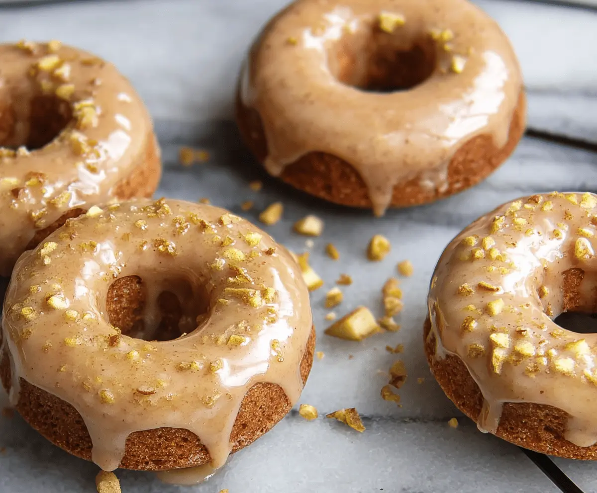 Delicious baked apple donuts topped with shiny glaze, ready to enjoy as a sweet breakfast or snack