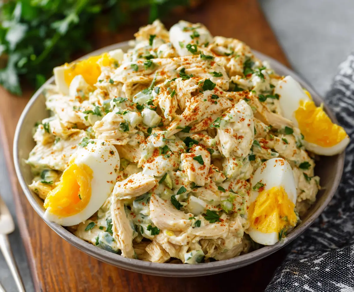 Delicious high-protein chicken and egg salad in a bowl, perfect for a healthy meal.