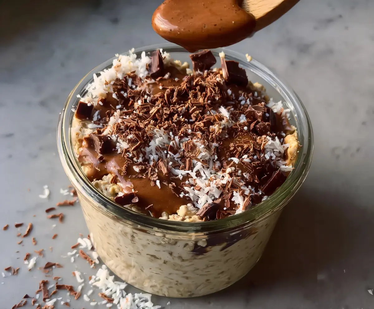 Creamy Samoa Cookie Overnight Oats topped with coconut, caramel, and chocolate for a delicious breakfast