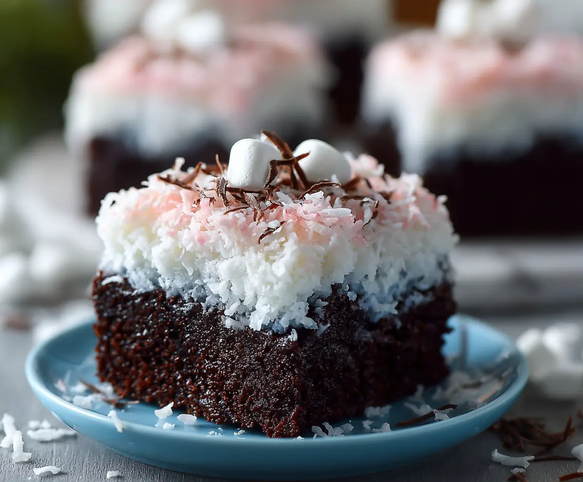 Delicious Sno Ball Brownies topped with fluffy marshmallow and shredded coconut, perfect for a quick dessert.